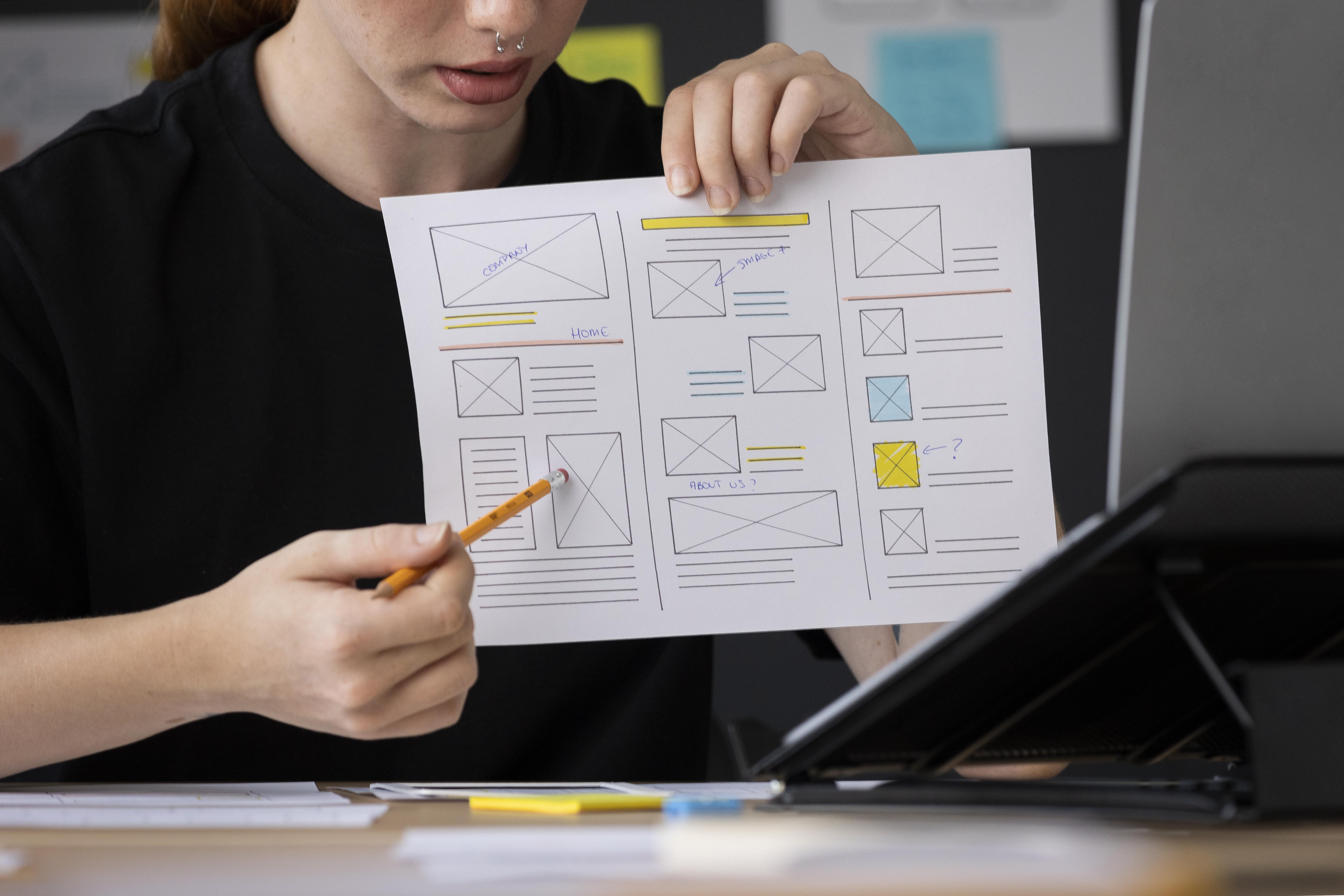 female web designer taking notes in office