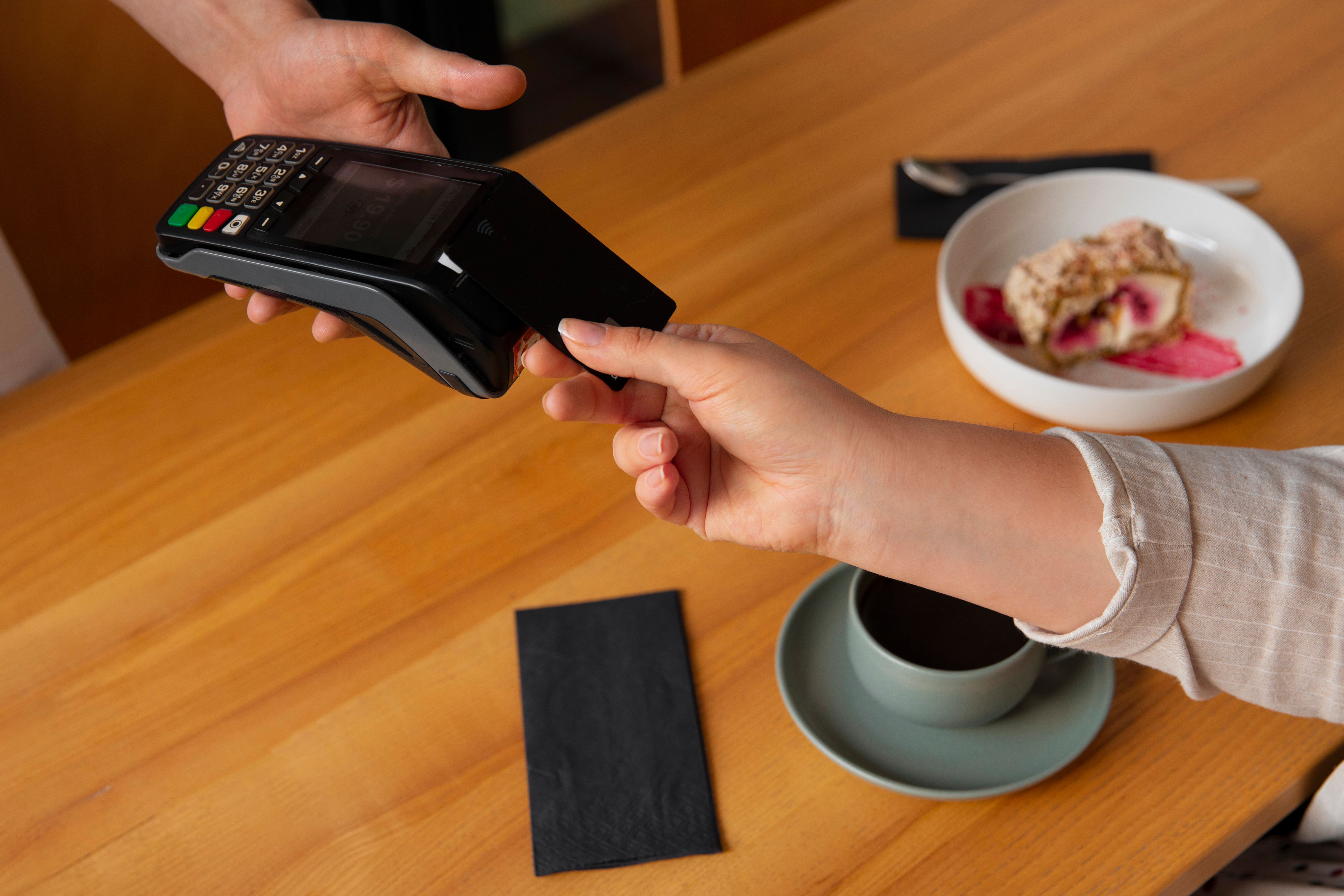 high-angle-customer-paying-with-nfc-device.jpg